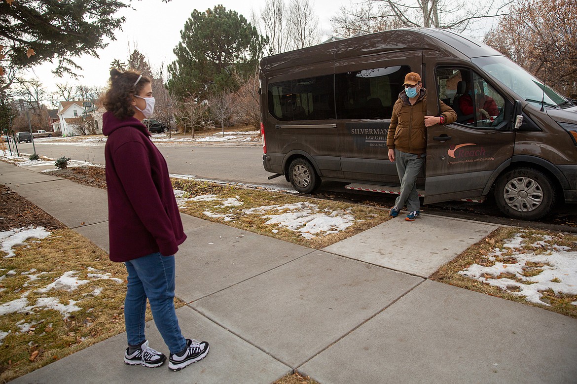 Suzan Mubarak visits with her boyfriend, Mitch Domier, from a distance during a weekly drive-by visit outside Mubarak’s group home in Bozeman. They don’t talk long — that’s saved for their nightly video chats, the only place they see each other's face without a mask. (Louise Johns for KHN)