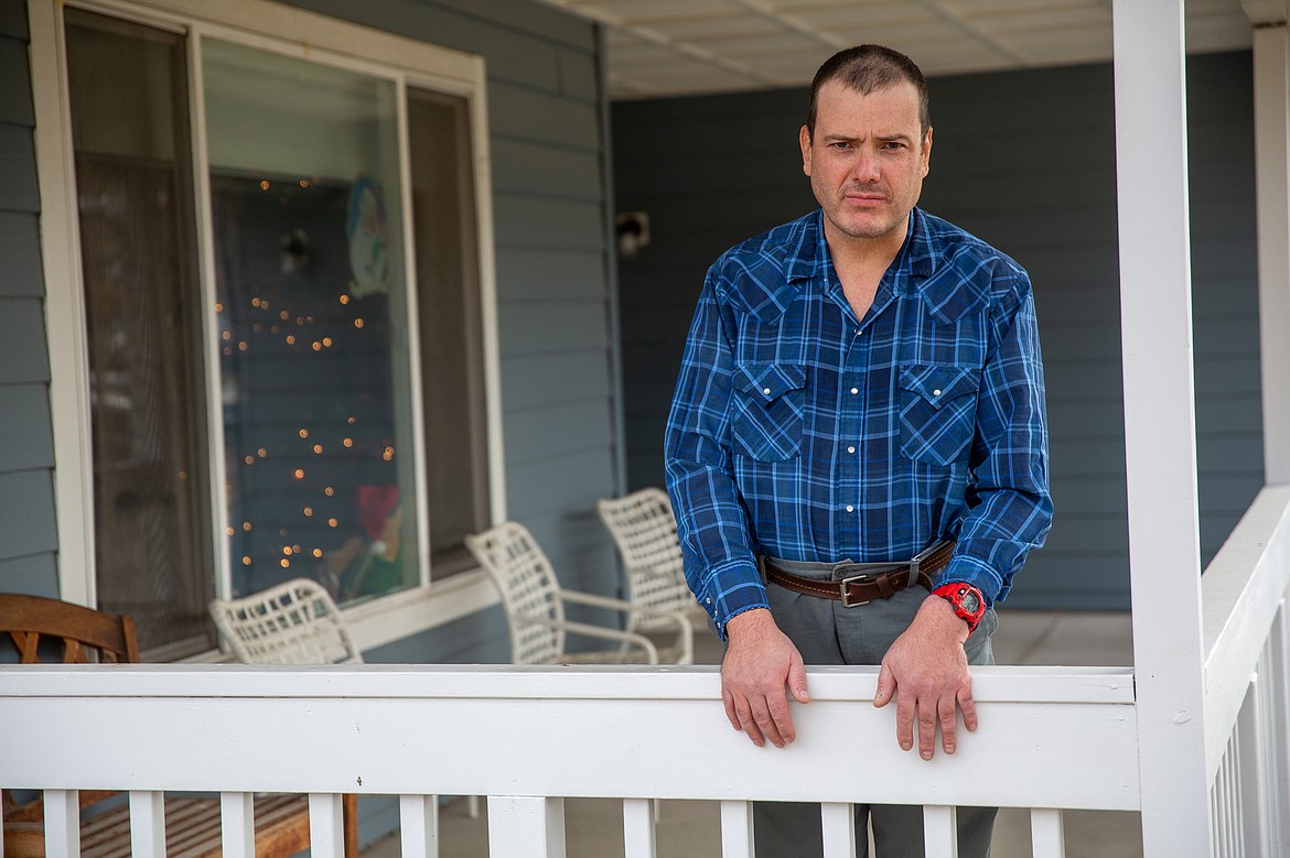 Mitch Domier stands outside his group home in Bozeman on Dec. 20, 2020. Aside from Domier’s weekly drive-by visits to girlfriend Suzan Mubarak’s group home a few miles away, the couple’s interaction during the pandemic has been limited to video chats. (Louise Johns for KHN)