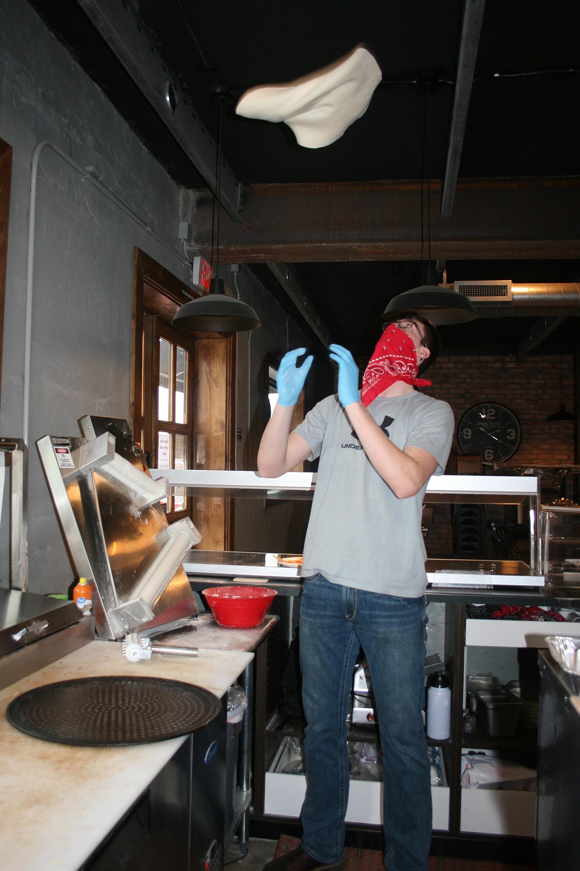 Ethan Small gives the pizza dough a toss in the kitchen of his family's restaurant, Smulligan's, in Royal City. Ethan's dad Warren wanted to learn to cook good barbecue, and learning to make pizza was a side benefit.