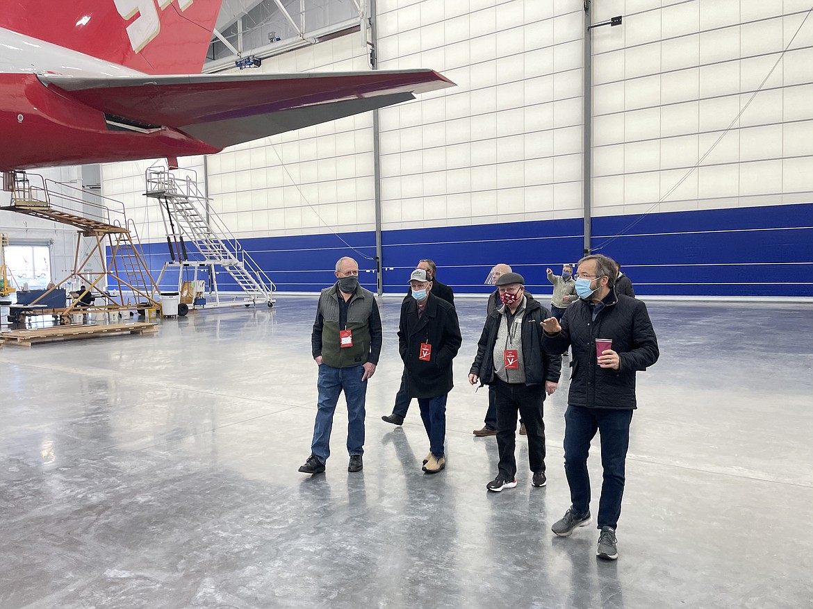 AeroTEC CEO and President Lee Human (right, foreground) shows Moses Lake City Council Member Mike Riggs (to his left) and Grant County Public Utility District Commissioner Dale Walker, as well as other visitors, Wednesday morning around the company's newly completed jumbo jet hangar, which is big enough to hold one 747 and two 737s at the same time.