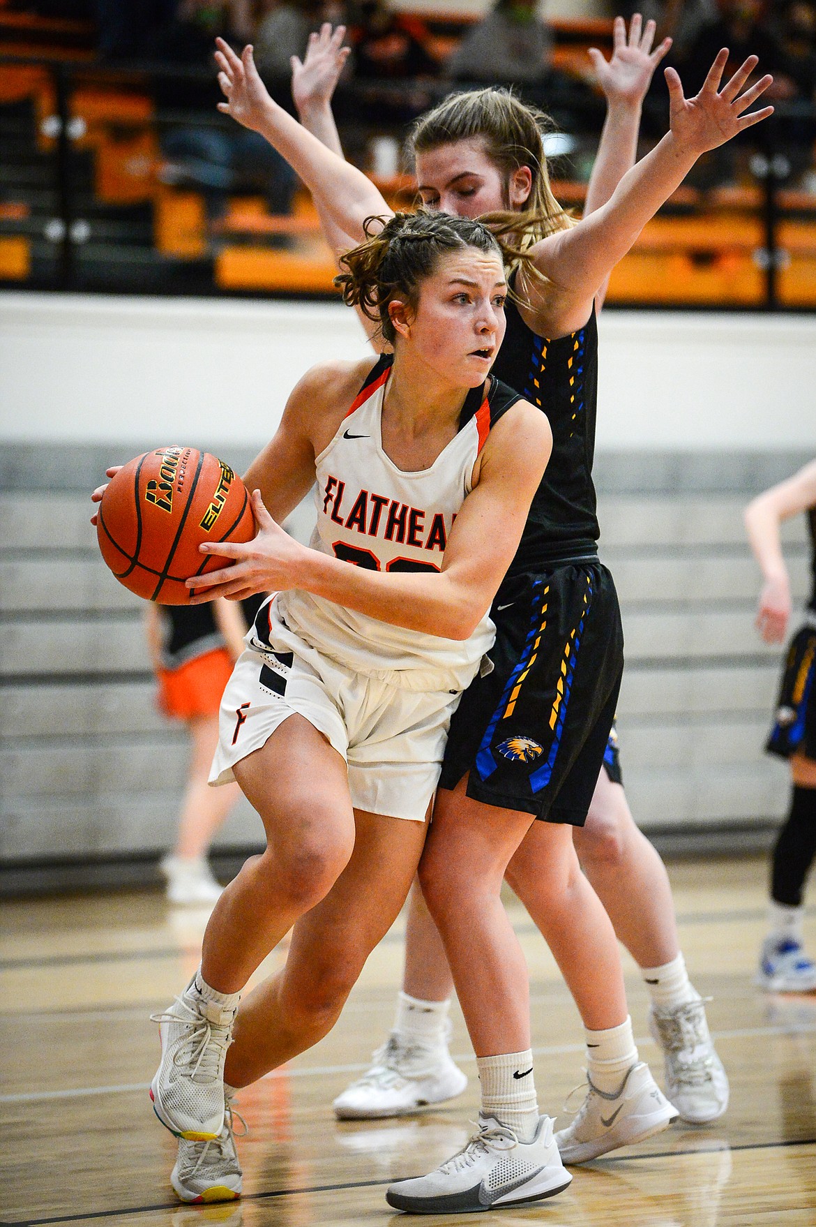 Flathead's Bridget Crowley (20) looks for a passing lane under the basket against Missoula Big Sky at Flathead High School on Thursday. (Casey Kreider/Daily Inter Lake)