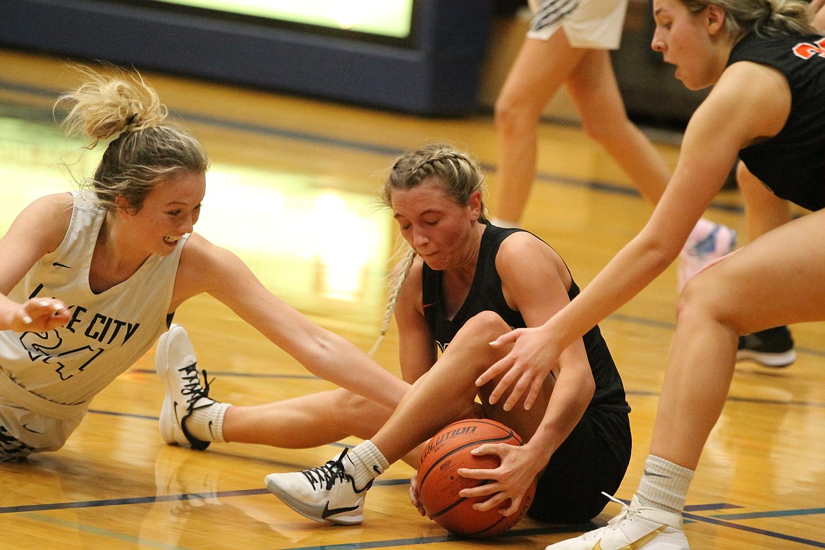 JASON ELLIOTT/Press
Lake City forward Brenna Hawkins attempts to grab the basketball from the hands of Post Falls guard Dylan Lovett during the third quarter of Friday's 5A Region 1 tournament game at Lake City High.