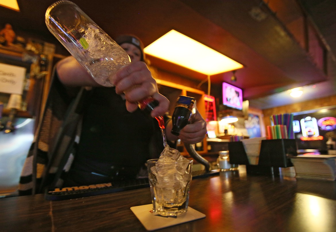 Bartender Jaki Whitmore pours a drink Thursday evening. According to a survey conducted by DrugAbuse.com, drinkers in Idaho consumed 714 alcoholic drinks a week last year, while American drinkers in general had 17 alcoholic beverages a week.