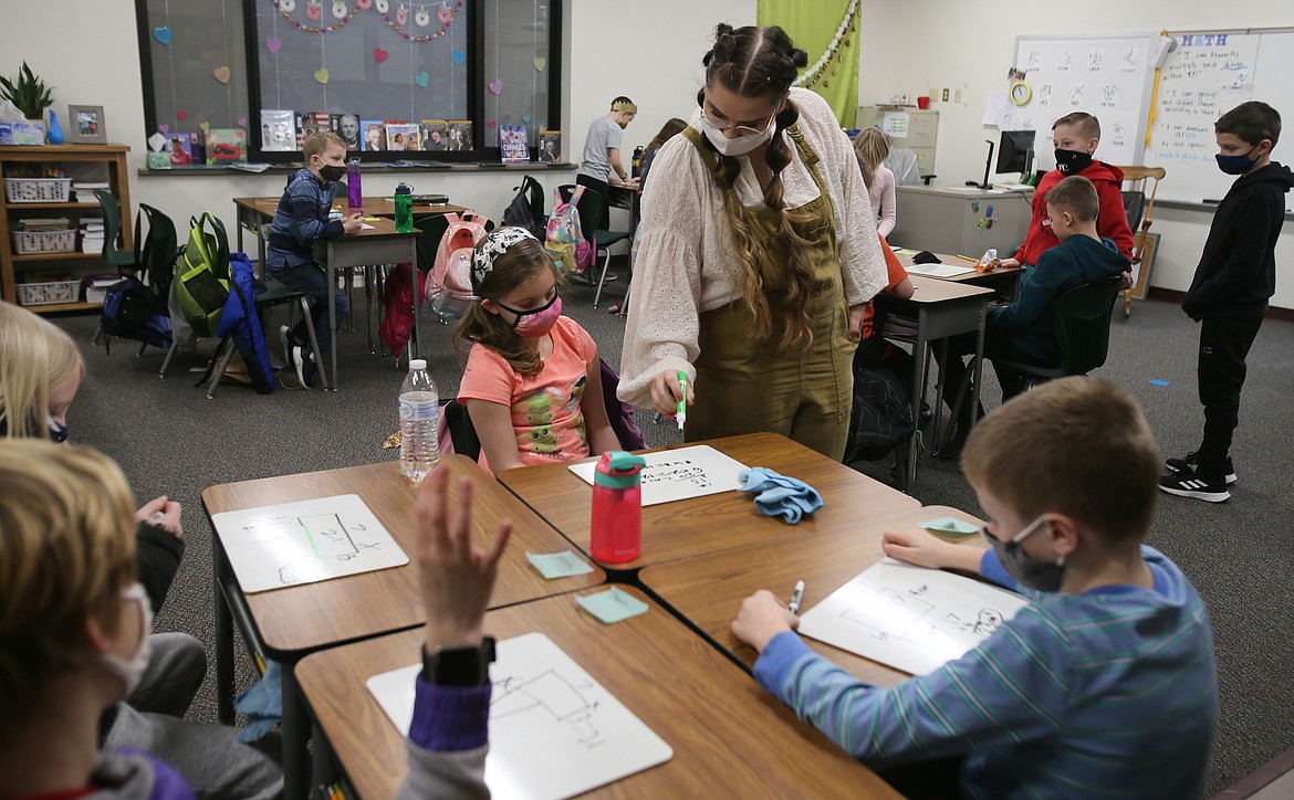 Teacher Alla Burlakov checks third-grader Bailey Oglesbee's math work during class on Tuesday. The March 9 levy for the Post Falls School District, if approved, will help to keep quality teachers in the district.