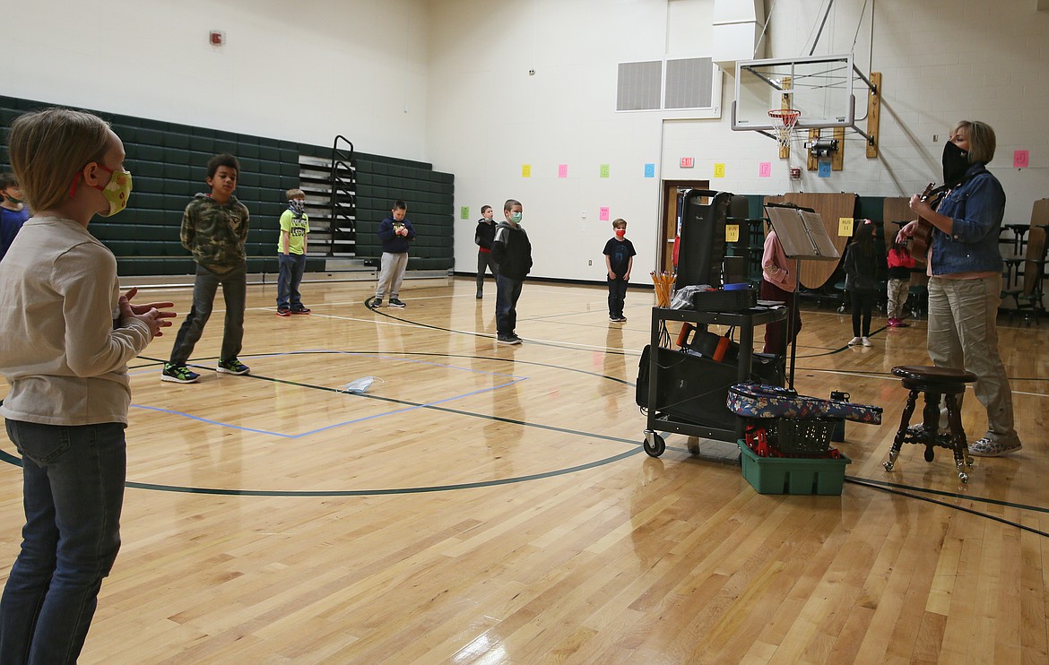 Tracie Schmidt leads a music class in the gym at Greensferry Elementary on Tuesday. Extracurricular activities and arts programming are among the many items supported by supplemental levy funds, which comprise about 7.5% of the district’s budget.