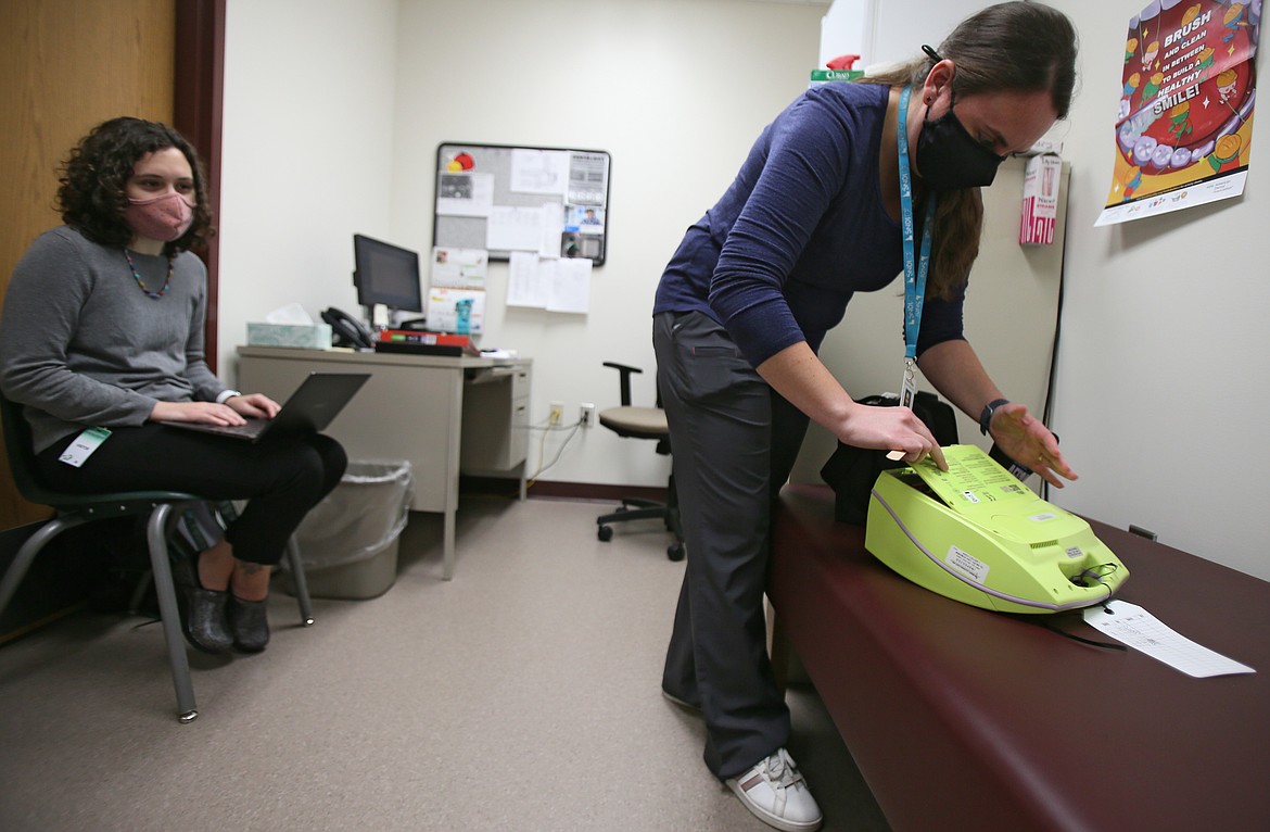 Post Falls School District lead nurse Elizabeth Costin, right, inspects the automated external defibrillator at Greensferry Elementary School on Tuesday as nurse-in-training and Washington State University student Olivia DuPuy observes. School nurse positions are supported by funds from supplemental levies. Post Falls' next levy is coming up March 9.