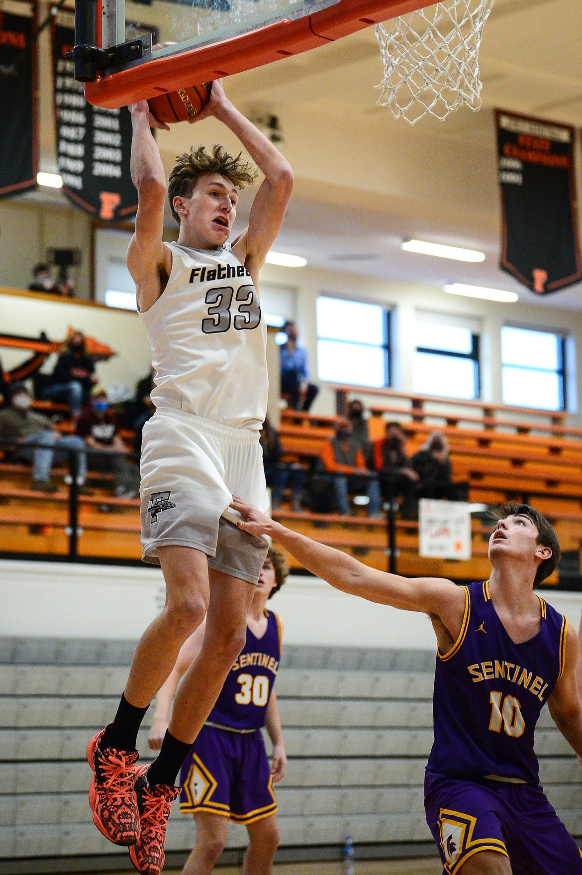 Flathead's Ezra Epperly (33) grabs a rebound against Missoula Sentinel at Flathead High School on Saturday. (Casey Kreider/Daily Inter Lake)