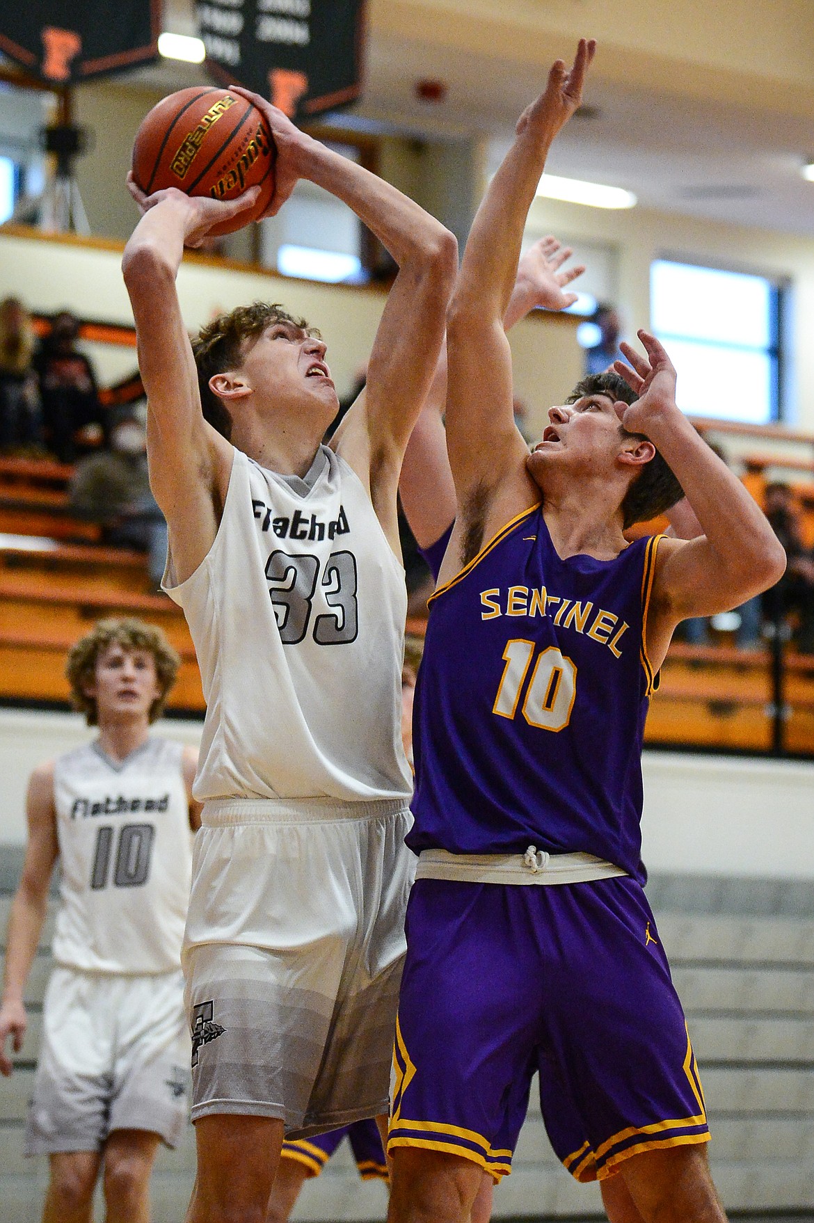 Flathead's Ezra Epperly (33) looks to shoot over Missoula Sentinel's TJ Rausch (10) at Flathead High School on Saturday. (Casey Kreider/Daily Inter Lake)