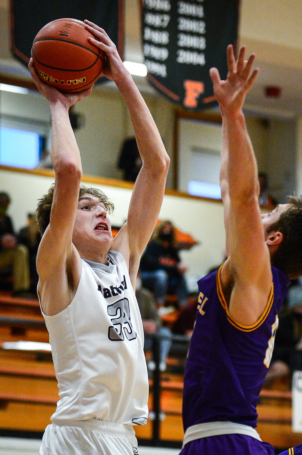 Flathead's Ezra Epperly (33) goes to the hoop against Missoula Sentinel's Soren Syvrud (12) at Flathead High School on Saturday. (Casey Kreider/Daily Inter Lake)