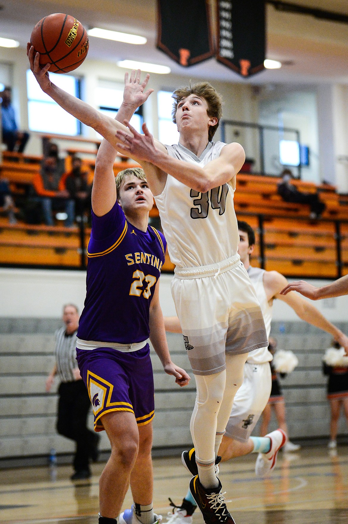 Flathead's Joston Cripe (34) gets to the hoop past Missoula Sentinel's Hayden Kolb (23) at Flathead High School on Saturday. (Casey Kreider/Daily Inter Lake)