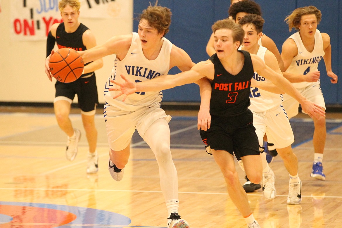 MARK NELKE/Press
Cameren Cope, left, of Coeur d'Alene, heads up the floor as Caden McLean of Post Falls reaches for the ball Saturday at Coeur d'Alene High.