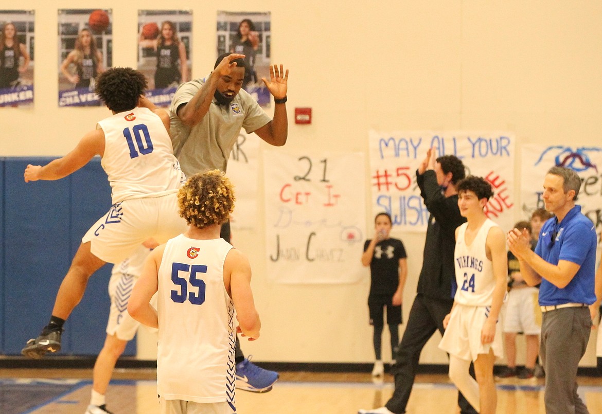 MARK NELKE/Press
Steven Burgess (10) of Coeur d'Alene and Viking assistant coach Shi Blake celebrate after Coeur d'Alene beat Post Falls on Saturday for the first time since 2016.