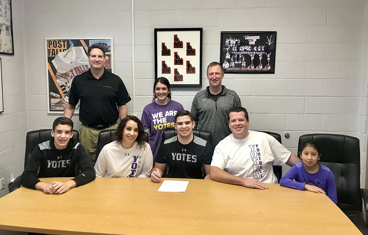 Courtesy photo
Post Falls High senior Josiah Shields recently signed a letter of intent to play football at NAIA College of Idaho in Caldwell. Seated from left are Alex Shields, Carolina Shields, Josiah Shields, Dan Shields and Angeley Shields; and standing from left, Craig Christensen, Post Falls High athletic director; Liberty Ortega; and Blaine Bennett, Post Falls High football coach.