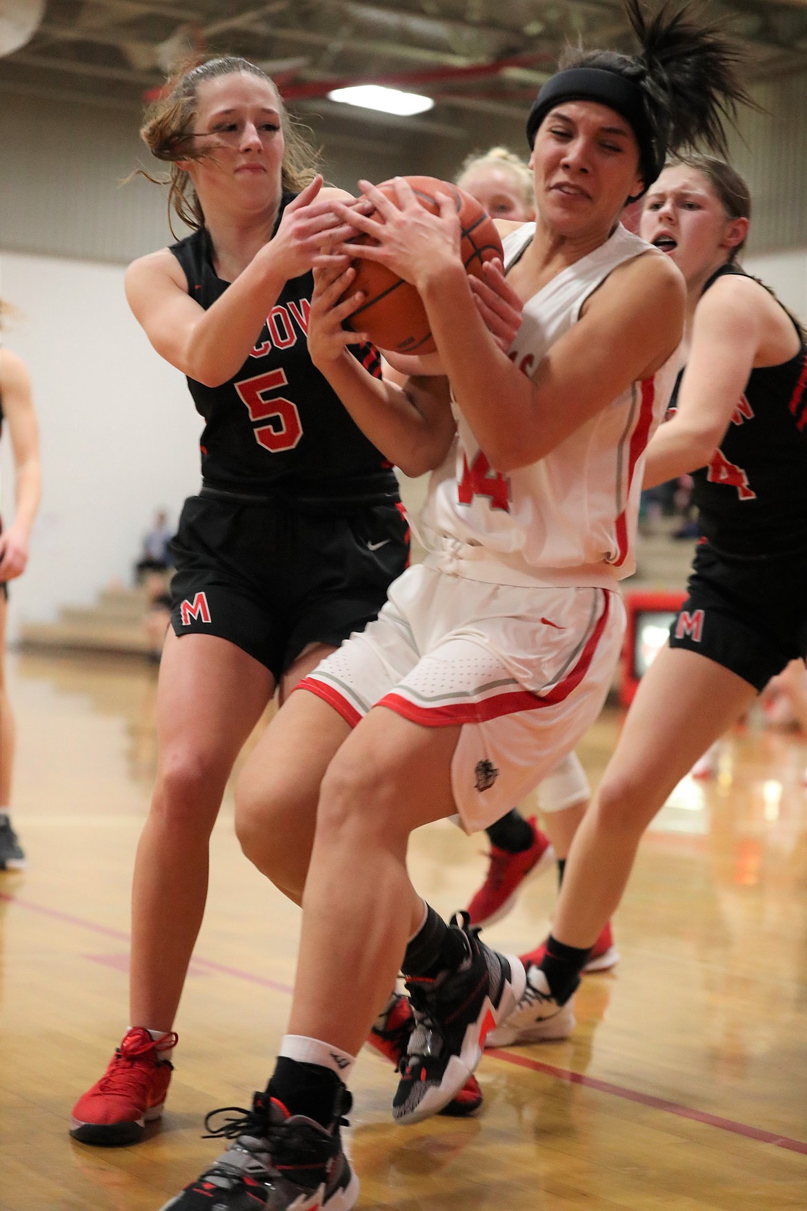 Senior Bella Phillips (right) fights for a rebound on Monday.