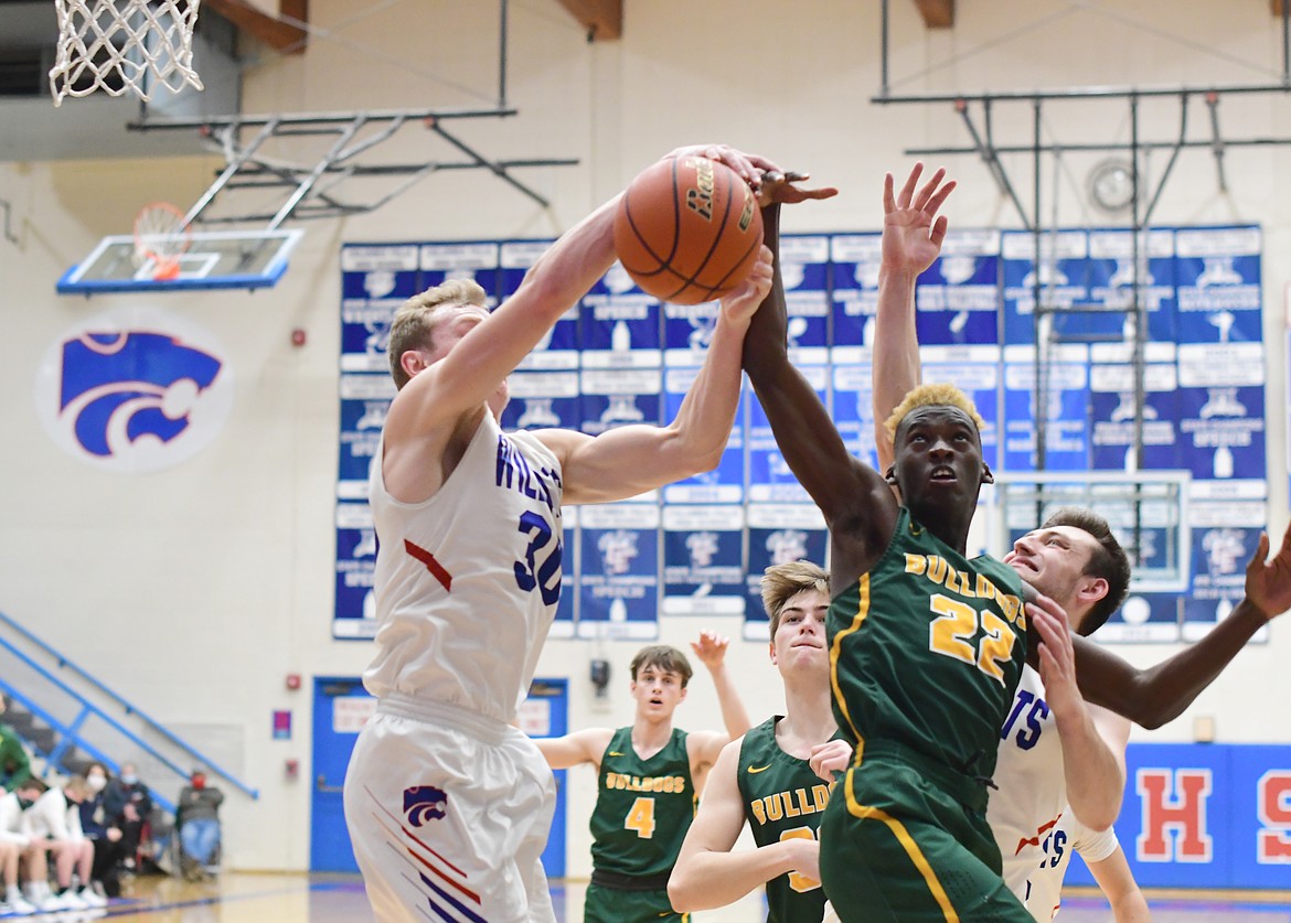 Marvin Kimera (22) battles for the rebound during Friday's game against Columbia Falls (Teresa Byrd/Hungry Horse News)