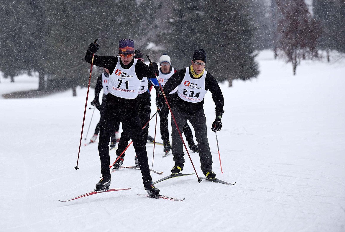 Nathan Basford, followed closely by Ryan Grenier, leads a group of skiers in the 12K race Saturday morning during the Winter Carnival freestyle ski race at Whitefish Lake Golf Club. (Heidi Desch/Whitefish Pilot)