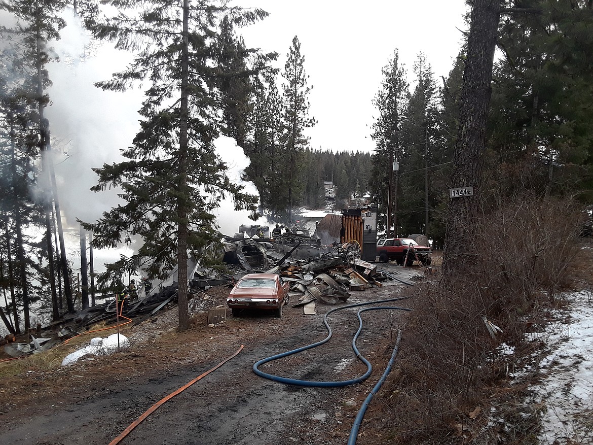 A Hayden Lake couple reportedly left to run errands for neighbors in need Monday morning, only to return to find their three-level home destroyed. (CRAIG NORTHRUP/Press)