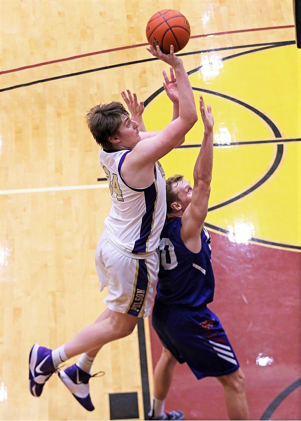 Trevor Lake rises for a shot in the paint against Columbia Falls. (Bob Gunderson)