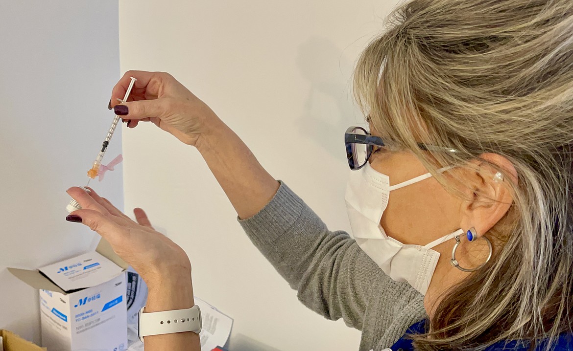 Nichole Moorhead, nurse manager with the Heritage Health Kellogg Clinic, prepares the coronavirus vaccine.