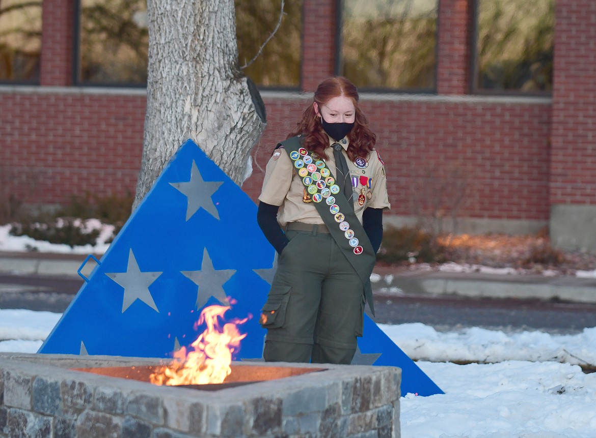 Eagle Scout Kaylee King looks on after starting a fire in the flag retirement pit she designed and finished at the Veteran's Home earlier this year. (Teresa Byrd/Hungry Horse News)