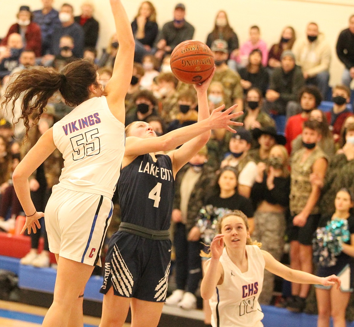 JASON ELLIOTT/Press
Coeur d'Alene's Skylar Burke attempts to block the shot of Lake City guard Sophia Zufelt during the first half of Tuesday's 5A Region 1 girls basketball championship game at Viking Court.