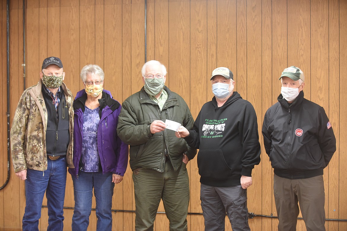 FLATHEAD WILDLIFE, INC. recently donated $1,000 to Flathead County 4-H Shooting Sports to help support their programs. From left, are 4-Hers Bill Voermans, Marsha Voermans, Flathead Wildlife’s Jim Vashro, 4-Hers Dale Saverud and Don Anderson. (Scott Shindledecker/Daily Inter Lake)