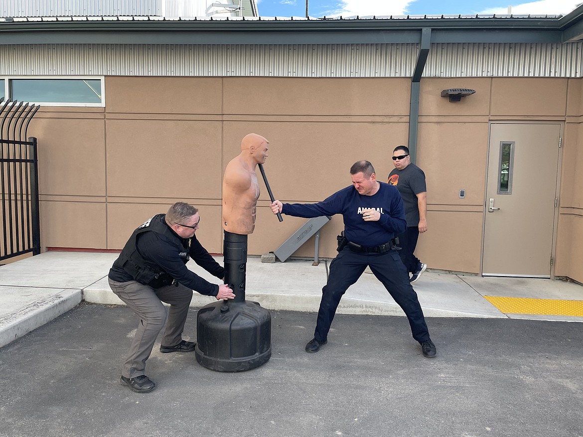 "Open your eyes!" yells Grant County Sheriff's Office Lt. Dean Hallett as he operates a combat dummy Quincy Police Officer Gary Amaral "fights it off" while QPD Community Service Officer Alan Talbot looks on. Amaral had just been pepper sprayed, and had to "fight" the dummy for two minutes.