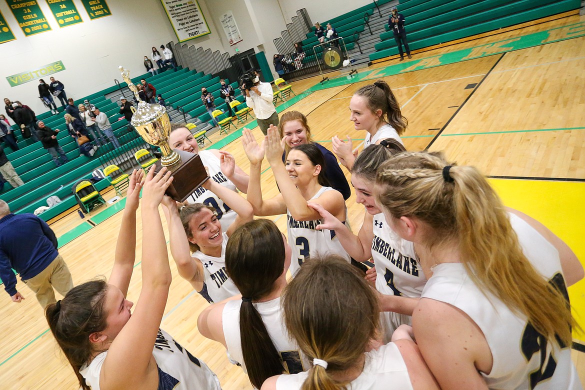 JASON DUCHOW PHOTOGRAPHY
Taryn Soumas holds the trophy as Timberlake celebrates its seventh straight 3A District 1 girls basketball championship Tuesday in Rathdrum.