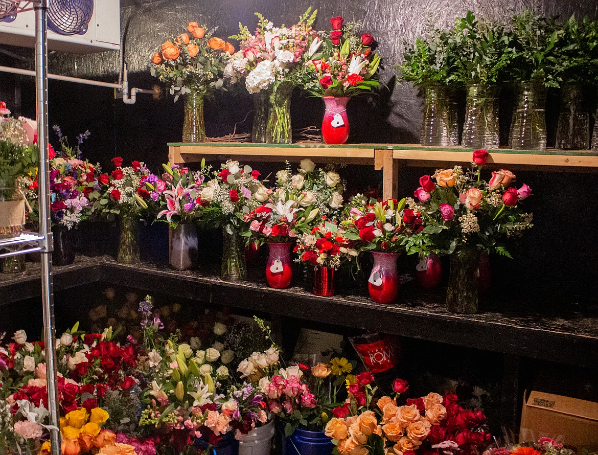 Flower arrangements fill the floor and shelves inside the flower cooler at Floral Occasions floral shop in Moses Lake on Wednesday.