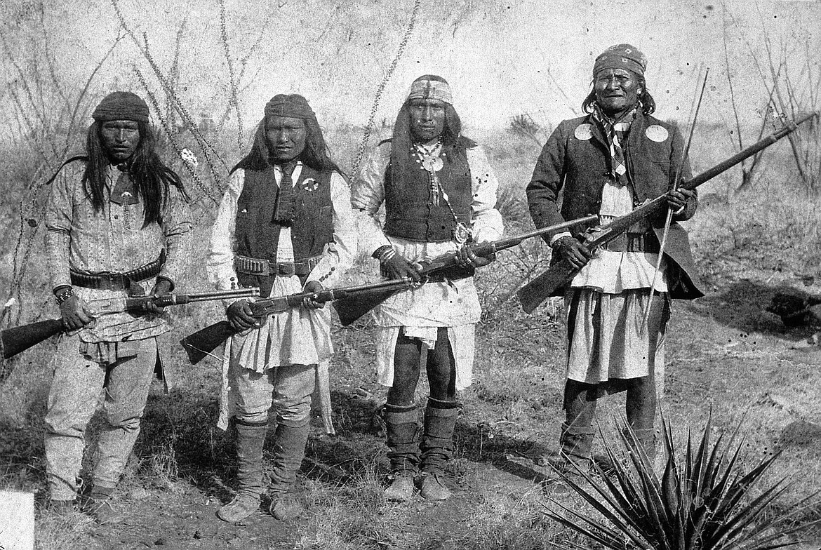 Apache leader Geronimo on right, Yanozha (Geronimo's brother-in-law), Chappo (Geronimo's son by his second wife), and Fun (Yanozha's half-brother) (1886).