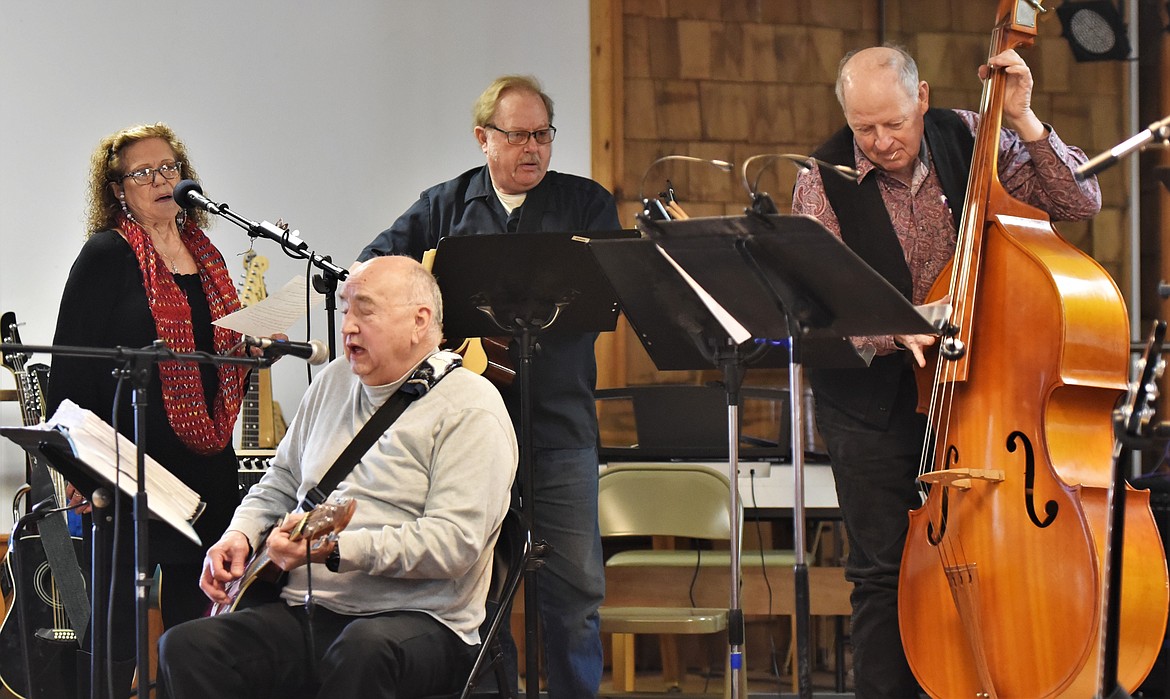 From left: Betty Carter, Ken Kenmille, Dale Iseman and Wally Congdon play "Rolling in My Sweet Baby's Arms" with several others not pictured. (Scot Heisel/Lake County Leader)