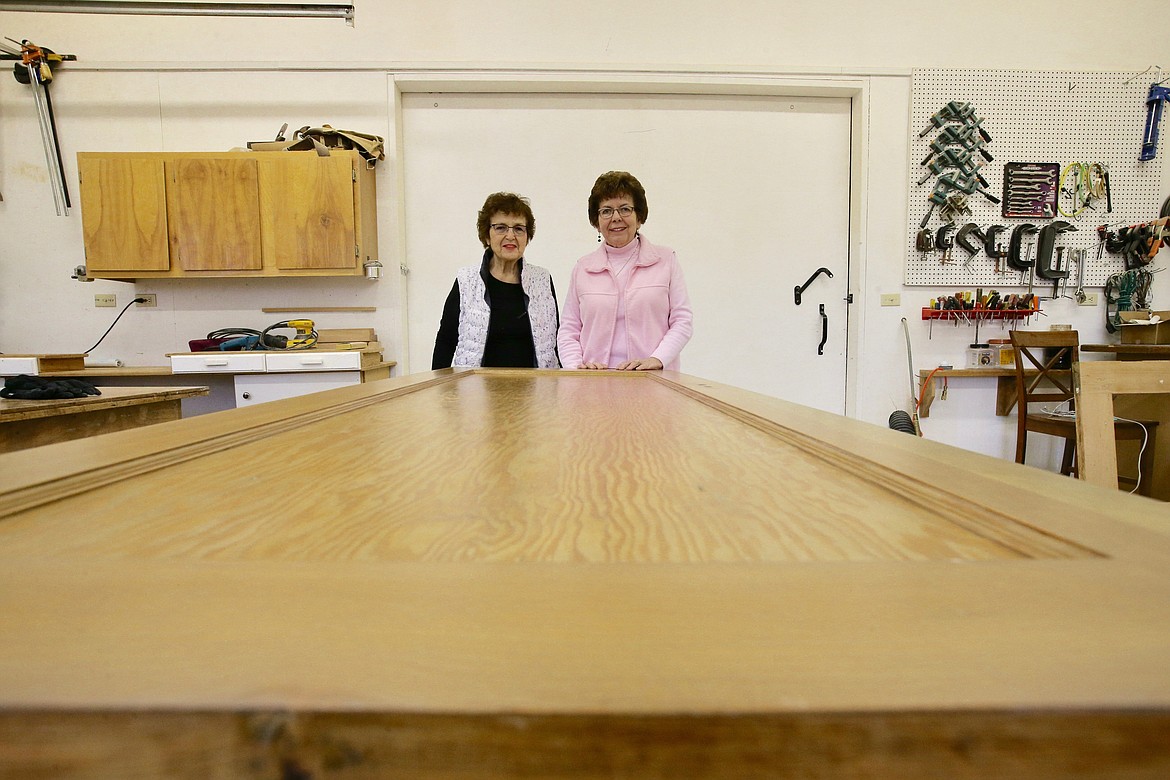 Carolyn Lyden, right, and Colleen McCracken stand by a door they're restoring in the shop at Lyden's Hayden home.