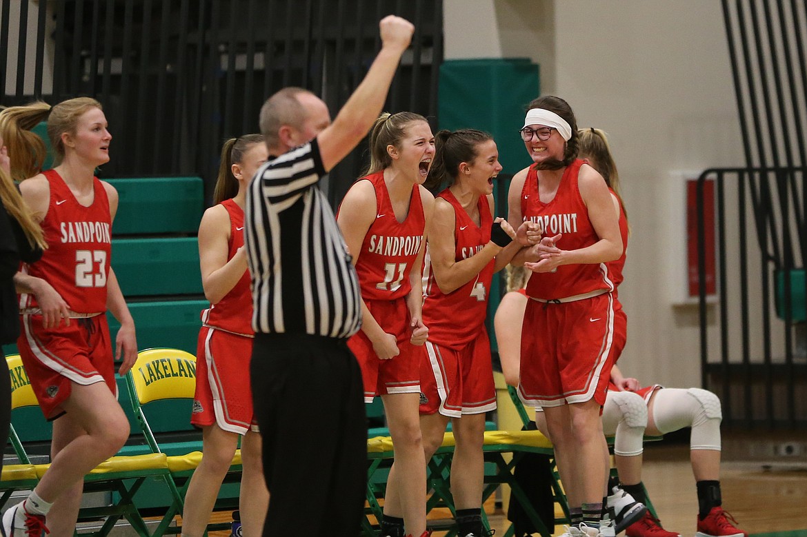 The Sandpoint bench celebrates after a foul is called on a desperation 3-pointer by Daylee Driggs with 0.7 seconds left in Wednesday's district game.