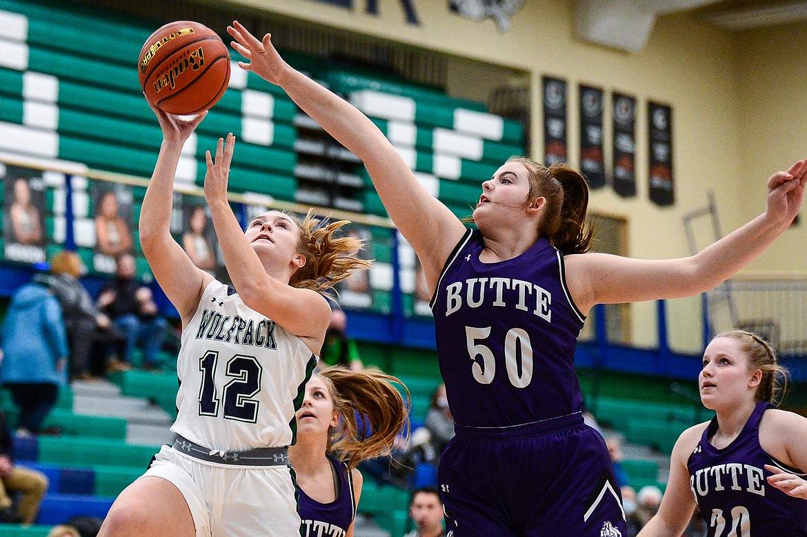 Glacier's Kenzie Williams (12) beats Butte's Ashley Olson (50) to the basket at Glacier High School on Thursday. (Casey Kreider/Daily Inter Lake)