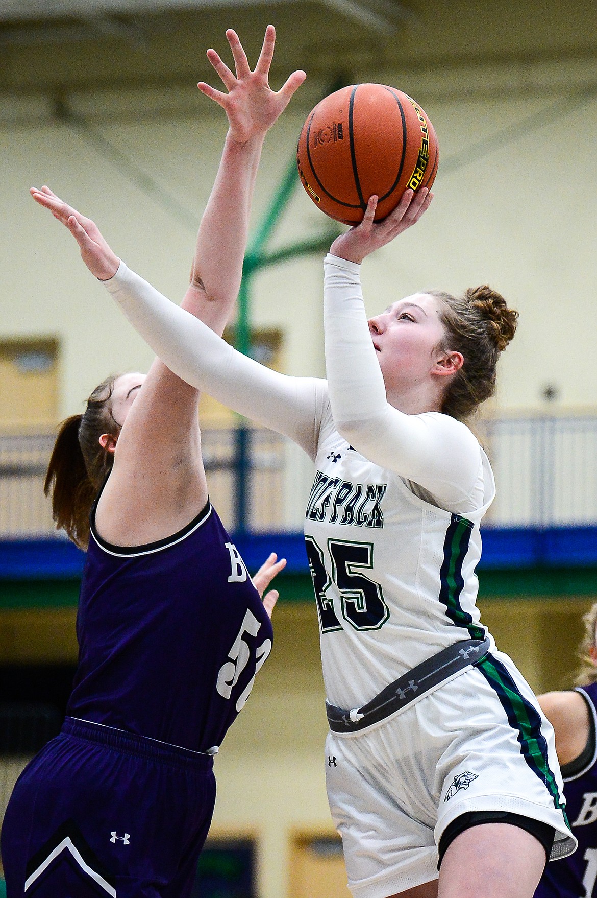 Glacier's Emma Anderson (25) shoots over Butte's Ashley Olson (50) at Glacier High School on Thursday. (Casey Kreider/Daily Inter Lake)