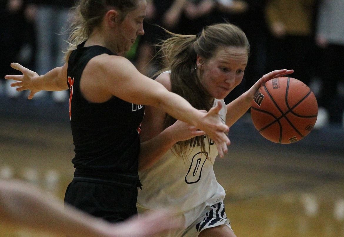 JASON ELLIOTT/Press
Lake City point guard Kendall Pickford attempts to dribble past Post Falls guard Dylan Lovett during the second half of Thursday's 5A Region 1 basketball second-place game at Lake City High.