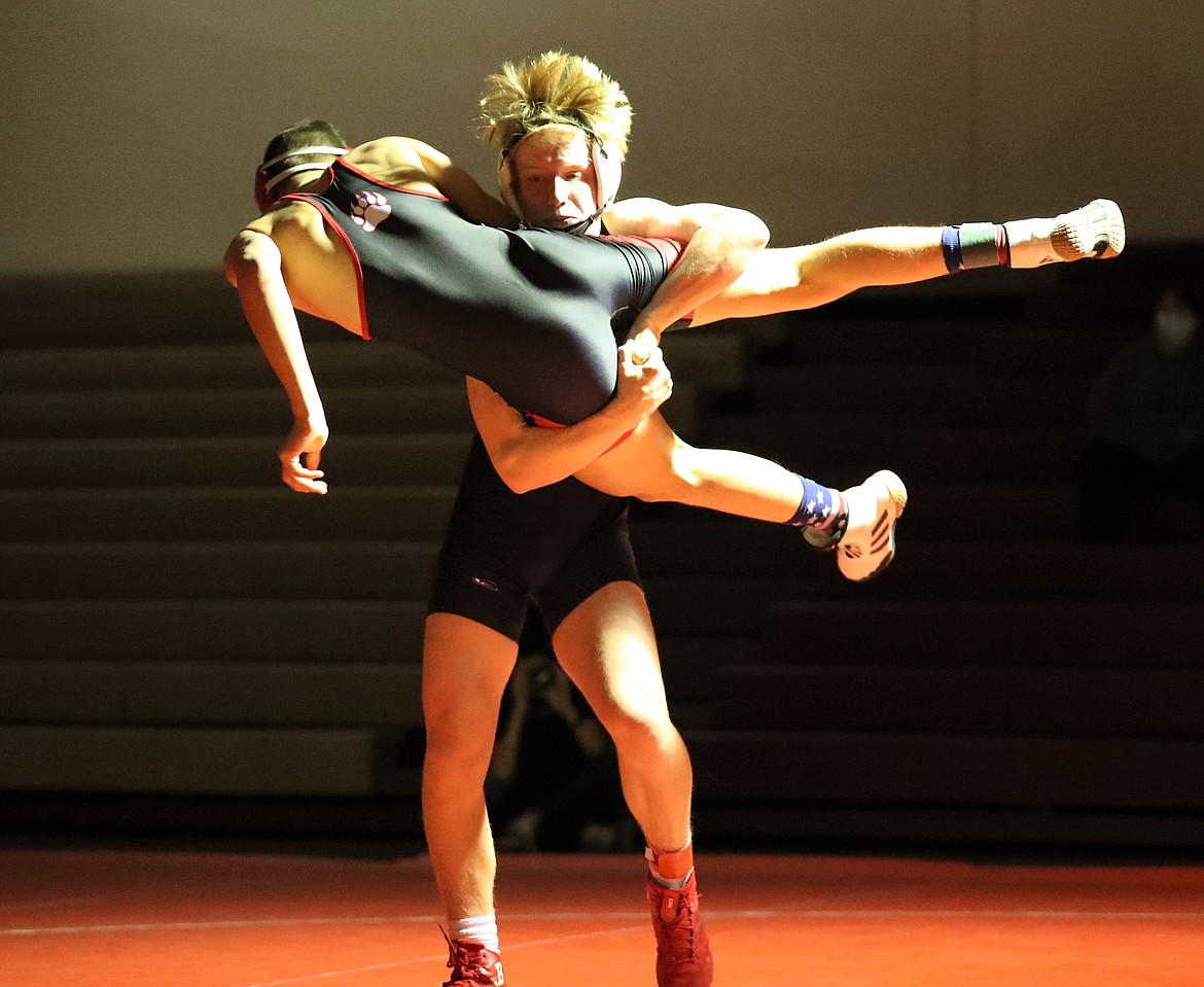 Freshman Shane Sherrill picks up Moscow's Jack Bales in a 132-pound bout on Thursday.