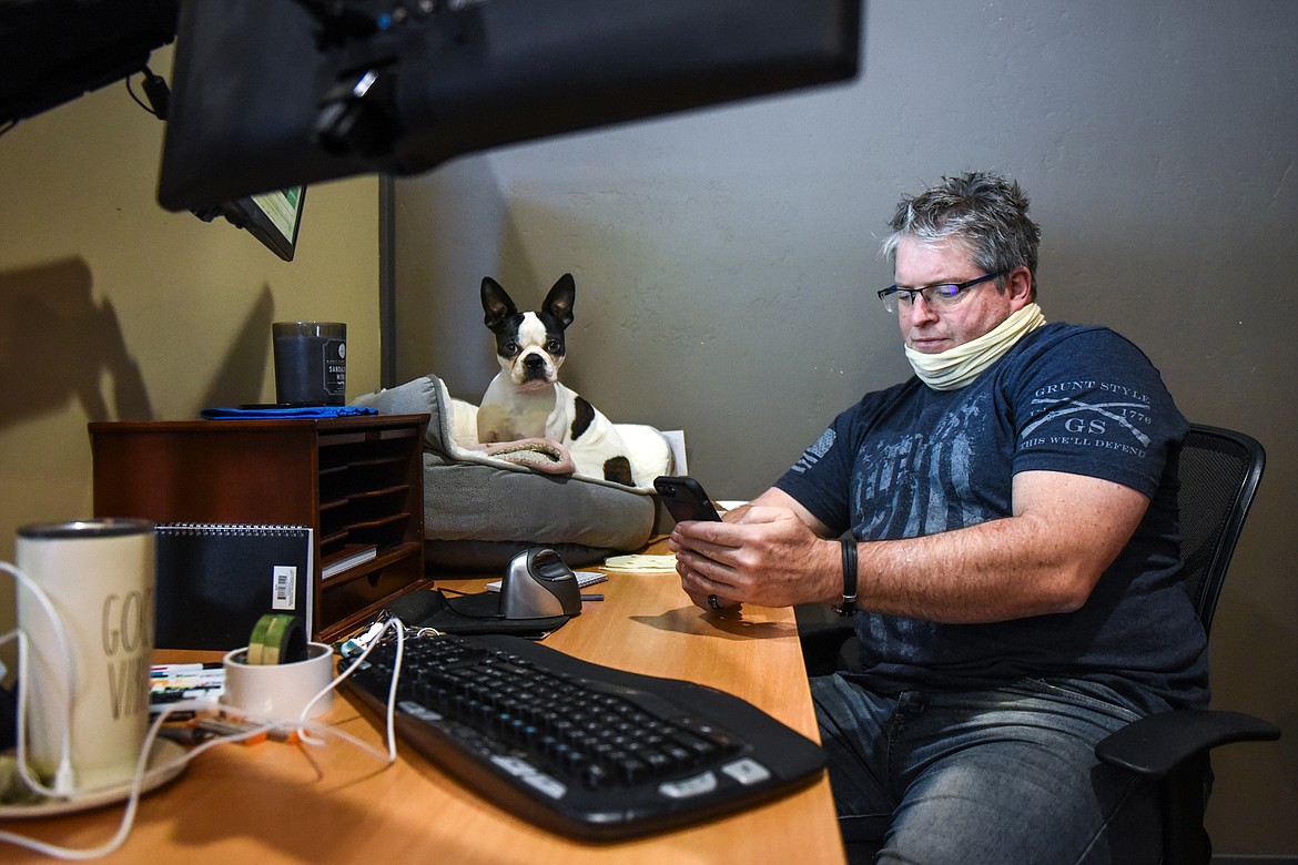 Brandon Squires, of Hungry Horse, works at one of the dedicated desks with his Boston terrier Bixly at Basecamp Coworking in Whitefish on Thursday, Feb. 11. Squires sells insurance and day trades. (Casey Kreider/Daily Inter Lake)