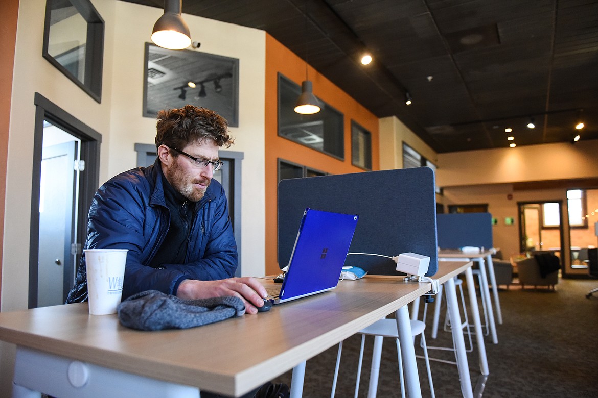 Will Dickinson, of Whitefish, works at one of the hotdesks at Basecamp Coworking in Whitefish on Thursday, Feb. 11. Dickinson works remotely for a ski company doing data analysis and business intelligence. (Casey Kreider/Daily Inter Lake)