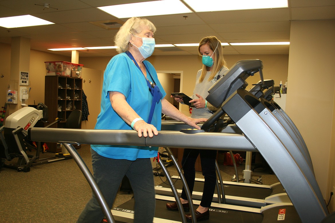 Petra Hovland (foreground) walks the treadmill, monitored by exercise specialist Megan Peters. Hovland is a patient in the cardiac rehabilitation program at Samaritan Hospital.