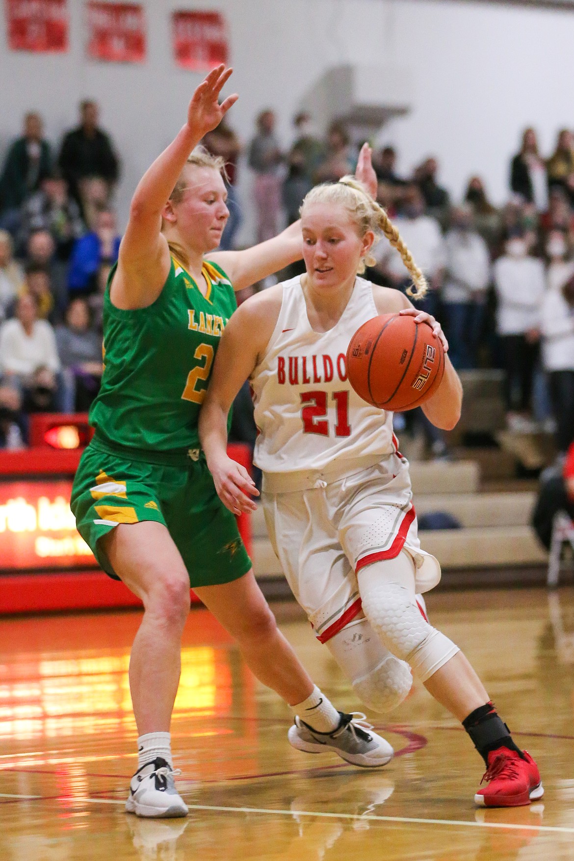 Senior Hattie Larson (right) drives to the basket during Game 2 of the best-of-3 4A Region 1 championship series at Les Rogers Court on Feb. 12.