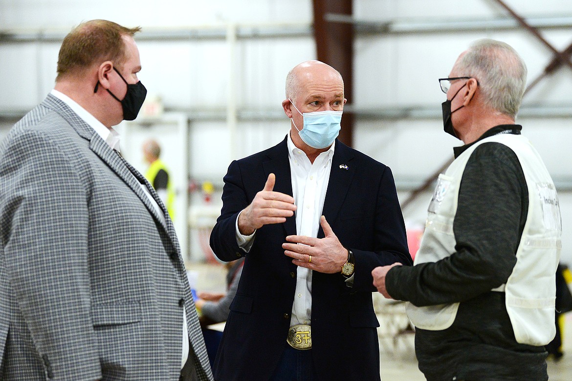 Gov. Greg Gianforte speaks with Joe Russell, right, Flathead County Health Officer, and Ryan Pitts, left, Chief Nursing Officer and Incident Commander of COVID-19 Response for Kalispell Regional Healthcare, during a tour of a COVID-19 vaccine clinic at the Flathead County Fairgrounds in Kalispell on Friday, Feb. 12. (Casey Kreider/Daily Inter Lake)