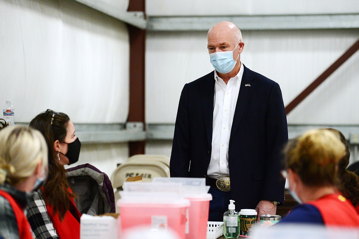 Gov. Greg Gianforte speaks with a group of nurses during a tour of a COVID-19 vaccine clinic at the Flathead County Fairgrounds in Kalispell on Friday, Feb. 12. (Casey Kreider/Daily Inter Lake)