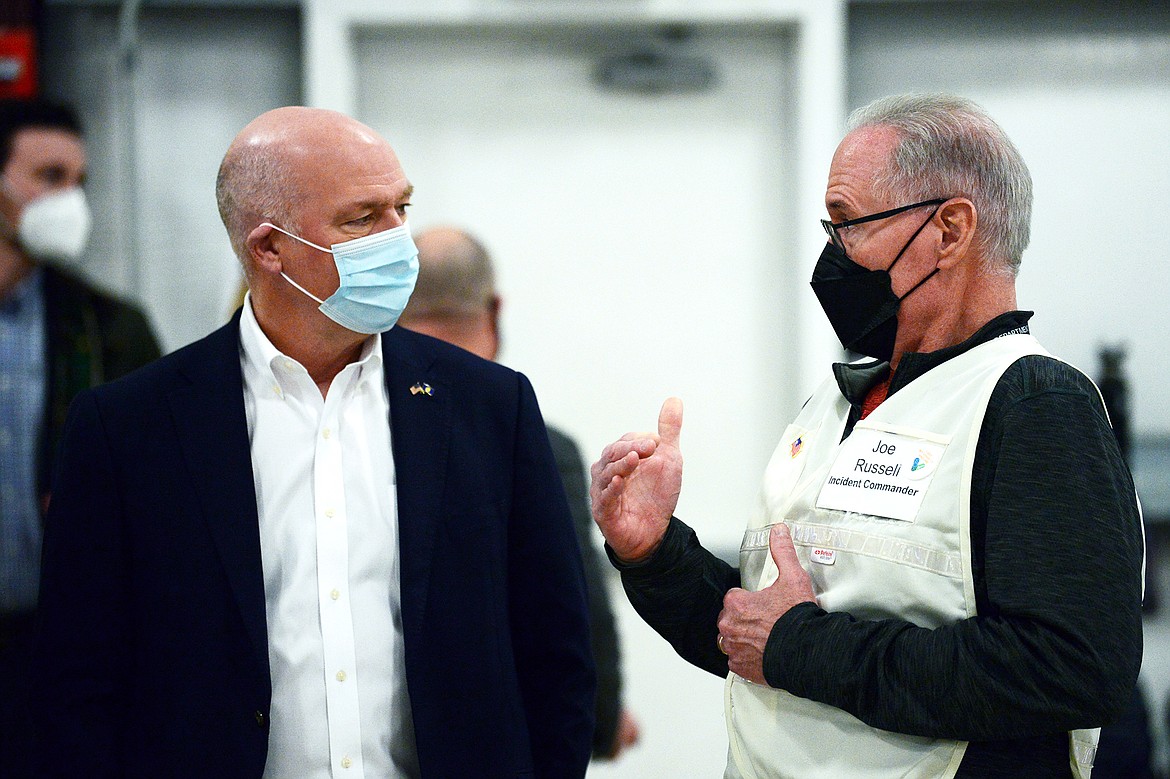 Montana Gov. Greg Gianforte speaks with Flathead County Health Officer Joe Russell during a tour of a Covid-19 vaccination clinic at the Flathead County Fairgrounds in Kalispell in this Feb. 12, 2021, file photo. (Casey Kreider/Daily Inter Lake)