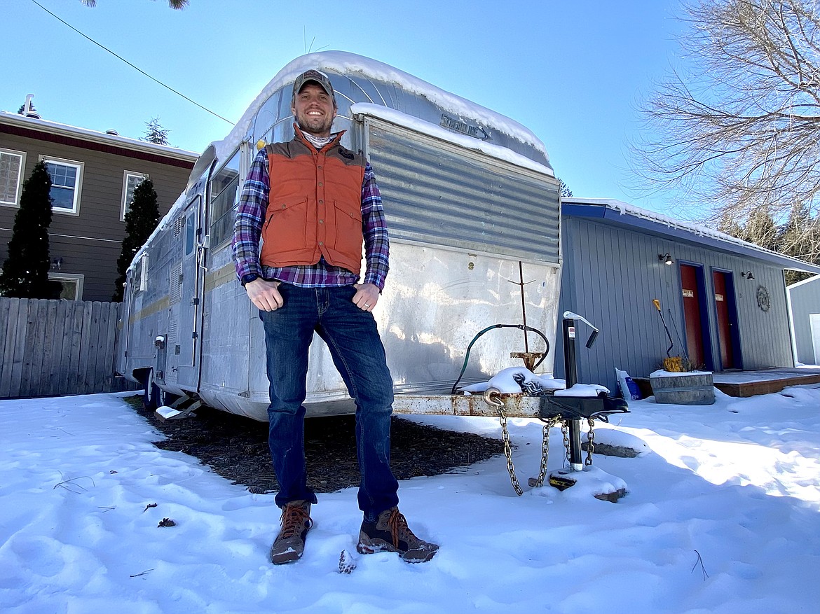Josh Schukman outside the Airstream camper where he's lived and worked for 5 years (photo credit Brittain Kovac).