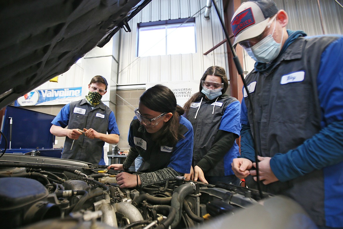 Lake City High students at the Kootenai Technical Education Campus peek under the hood of a Subaru during class Thursday morning. KTEC is funded proportionately by Coeur d'Alene, Lakeland and Post Falls school districts, with Coeur d'Alene providing about half of those funds, which come from supplemental levy money. The next levy vote is on the March 9 ballot. From left: Senior Daniel Osborn, junior Noelani Kawamura, junior Sophia Munoz and senior Riley Laughman.