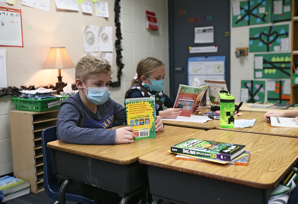 Gavin Sundberg and Elizabeth Ringger enjoy reading time in Priscilla Walsh's second grade class at Hayden Meadows Elementary on Thursday. The $20 million-per-year replacement levy for the Coeur d'Alene School District, if approved March 9, will provide the district with $40 million over two years.