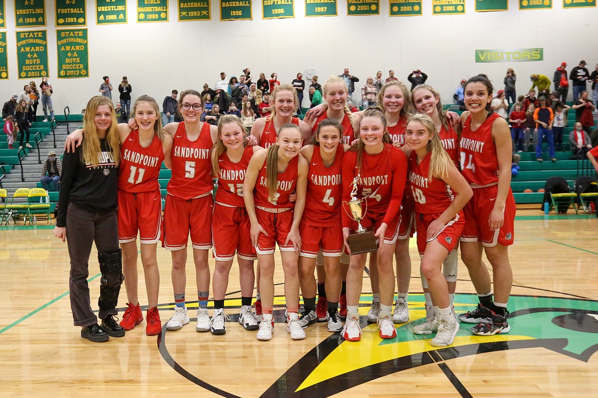 Sandpoint poses for a team photo with the 4A Region 1 trophy on Saturday.