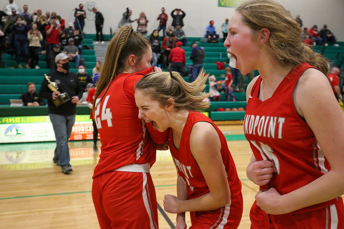 Kaylee Banks (left), Tru Tomco and Karlie Banks celebrate following Saturday's regional win over Lakeland at Hawk Court.