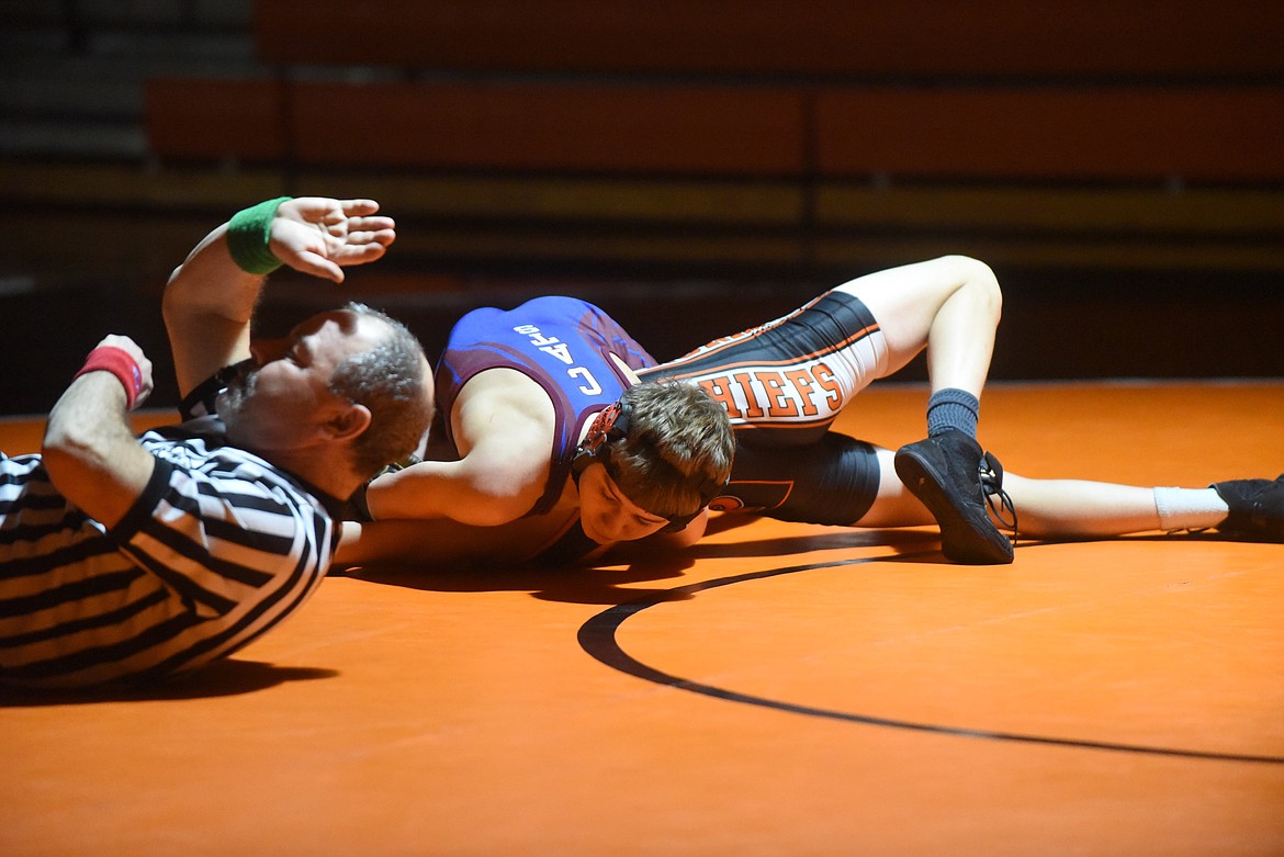 Official Tom Lindsay gets ready to slap the mat to signify a pin by Clark Fork’s Micha Acker of Ronan’s Ian Dillard during last Tuesday’s match. (Scott Shindledecker/Valley Press)